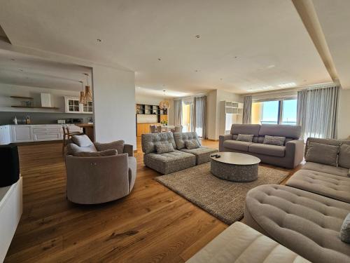a large living room with couches and a table at Stunning Seafront Portomaso Apartment in Paceville