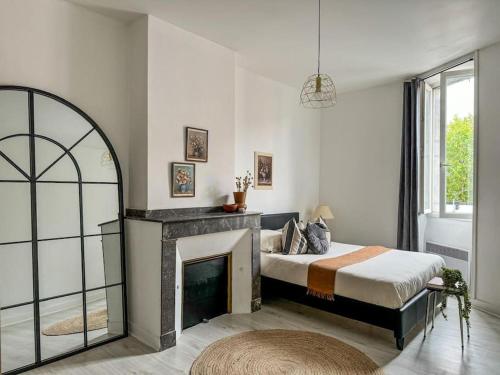 a bedroom with a bed and a fireplace at T3 Familial Pro Tarbes centre in Tarbes