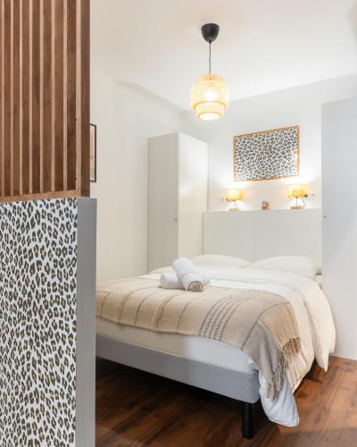 - une chambre blanche avec un lit dans l'établissement Le Rococo - Expérience léopard - Centre-ville, à Nantes