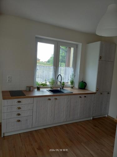 an empty kitchen with a sink and a window at Gawlasoowka in Inwałd