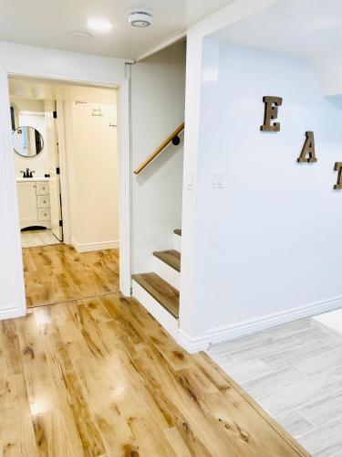 an empty room with a staircase and a white wall at Entire Guest Suite Pocatello in Pocatello