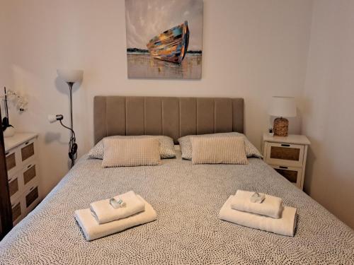 a bedroom with a bed with two towels on it at Apartment Summer in Šibenik