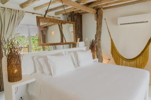Una cama o camas en una habitación de Éteka Slow Beach Hotel Adults Only