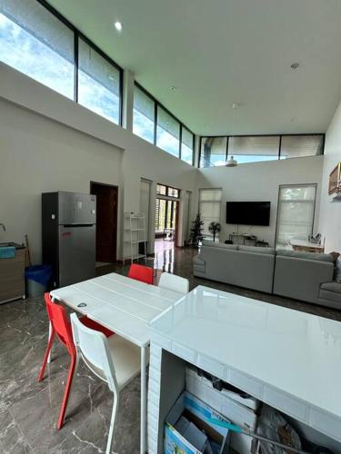 a living room with a white table and chairs at Mountain hills house poolvilla saraburi muaklek in Ban Sap Phrik