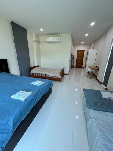 a room with two beds and a table in it at Mountain hills house poolvilla saraburi muaklek in Ban Sap Phrik