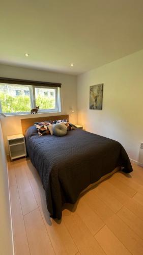 a bedroom with a large bed with a window at Les Terrasses de Malmedy - duplex 430 in Malmedy