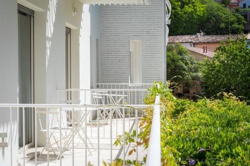 a balcony with a table and chairs on a house at Murè Hotel Numana in Numana