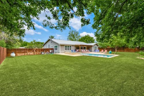 a yard with a pool and a house at Private Pool & Hot Tub! Charming Hill Country Home Minutes to Wineries/Shops! in Johnson City