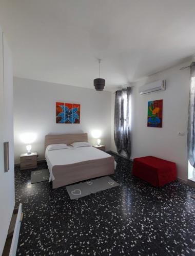 a bedroom with a bed and a red stool at Home Pugliese in Ceglie Messapica