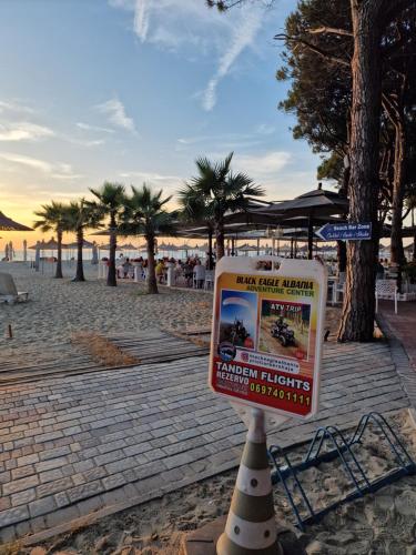a sign in the sand on a beach at Villa Pearl Adriatic Coast 2 in Golem