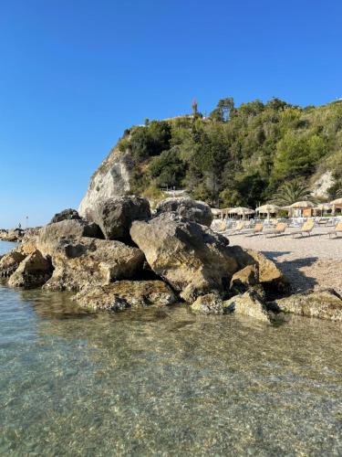 a group of rocks in the water on a beach at Murè Hotel Numana in Numana