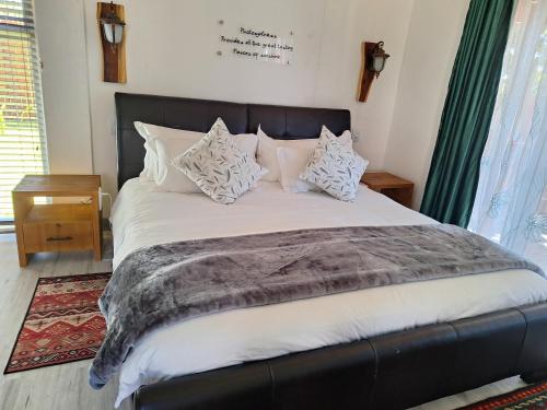 a bedroom with a large bed with pillows on it at Tree Living in Krugersdorp