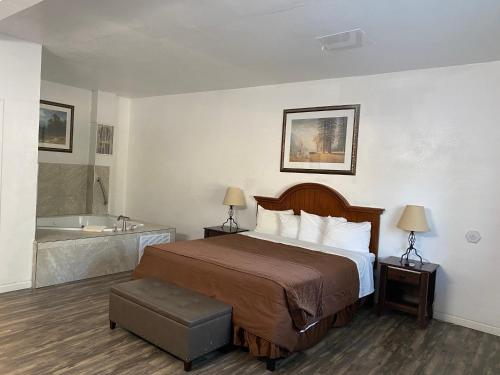 a hotel room with a bed and a bath tub at Big Pines Mountain House in South Lake Tahoe