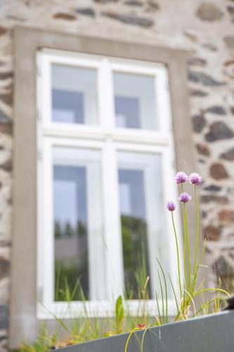 a window in a building with purple flowers in front of it at Chaloupka Křivoklát in Křivoklát