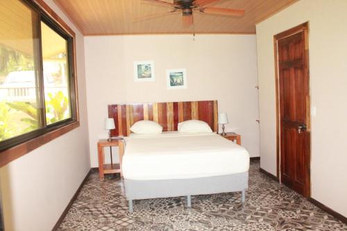 a bedroom with a bed and a window at Corcovado Private Houses-Villas-Tents-Nature-Relaxing in Puerto Jiménez