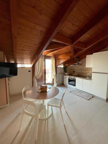 a kitchen with a table and chairs in a room at Vesux Apartments in Naples
