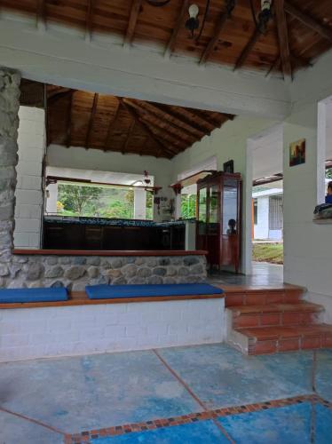 a room with a counter with blue cushions in it at Finca PiedrAlta Cisneros in Cisneros
