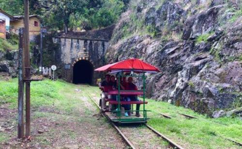 a group of people riding a train in a tunnel at Finca PiedrAlta Cisneros in Cisneros