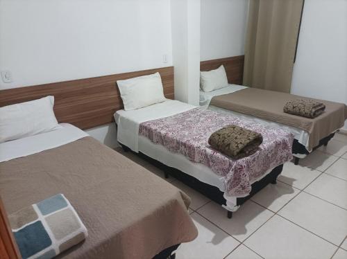Postel nebo postele na pokoji v ubytování Hotel João Luzia