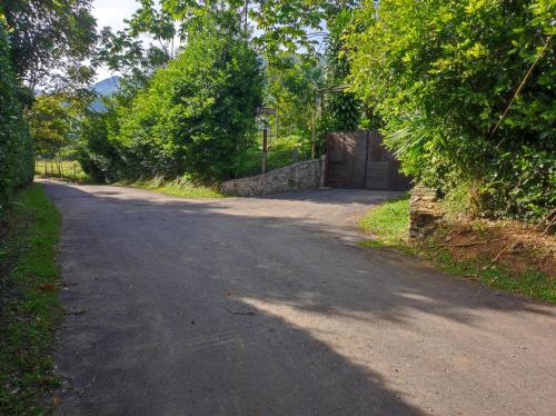 an empty road with a gate in the middle at Finca PiedrAlta Cisneros in Cisneros