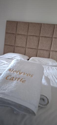 a bed with two white pillows on top of it at Villa Molivos Castle in Mithymna