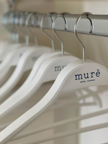 a row of white clothes hangers in a closet at Murè Hotel Numana in Numana