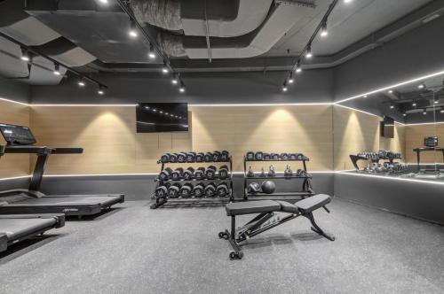 a room with a gym with a row of exercise equipment at Noru Hotel Malta - Adults Only Hotel in St Julian's