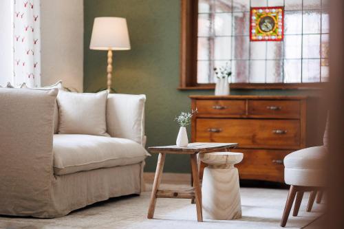 a living room with a couch and a table at Boutiquehotel Ochsen in Lenzkirch