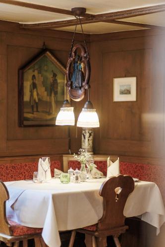 a dining room with a white table and chairs at Boutiquehotel Ochsen in Lenzkirch
