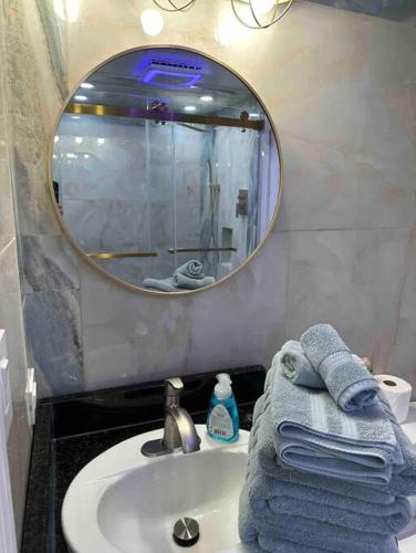a bathroom with a sink and a mirror and towels at Paradise at the Beach, Complete View of Horizon in Myrtle Beach