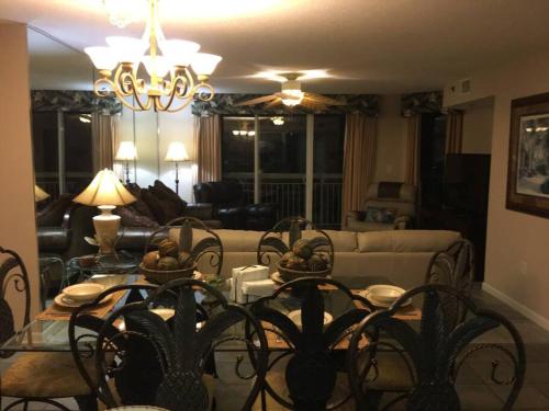 a living room with a table and chairs and a couch at Paradise at the Beach, Complete View of Horizon in Myrtle Beach