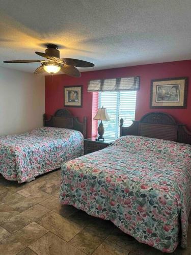 a bedroom with two beds and a ceiling fan at Paradise at the Beach, Complete View of Horizon in Myrtle Beach