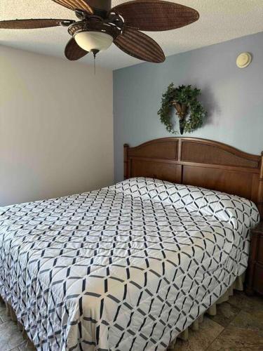 a bedroom with a bed with a ceiling fan at Paradise at the Beach, Complete View of Horizon in Myrtle Beach