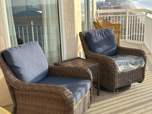 two wicker chairs and a ottoman on a balcony at Paradise at the Beach, Complete View of Horizon in Myrtle Beach