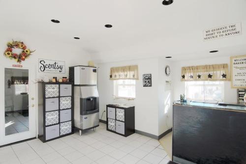 a kitchen with a refrigerator and a counter in a store at Baker City Motel & RV in Baker City