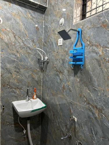 a bathroom with a sink and a shower at Duja Homes in Maihar