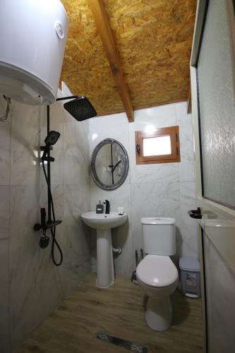 a small bathroom with a toilet and a sink at Vila Bajrami in Vlorë