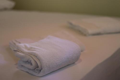 two folded towels sitting on a bathroom counter at Vila Bajrami in Vlorë