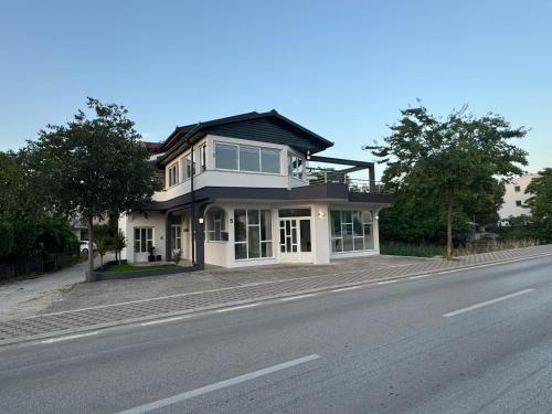a large house on the side of a road at Apartment Camellia 2 in Ljubuški