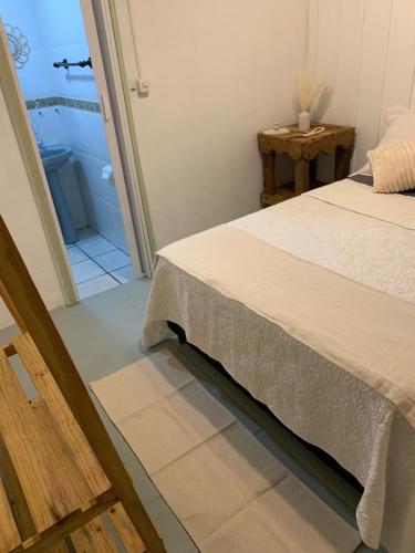 a bedroom with a bed and a bathroom at Pousada Bela Vista in Ilha do Mel