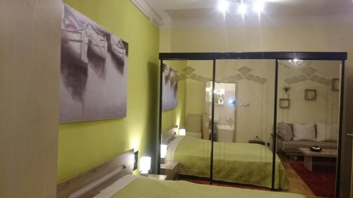 a bedroom with two beds and a mirror at Délibáb Apartment in Budapest