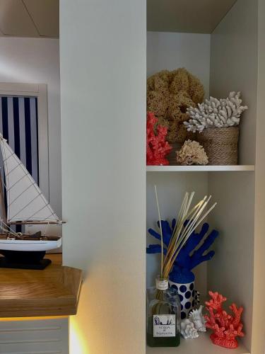 a shelf with some items in a room at Murè Hotel Numana in Numana