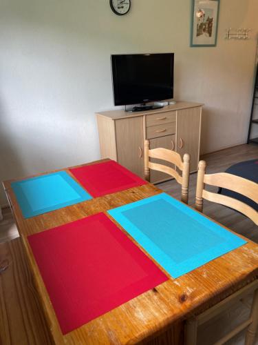 a table with a colorful blanket on top of it at Studio pied de pistes Tour de la Biche in Besse-et-Saint-Anastaise