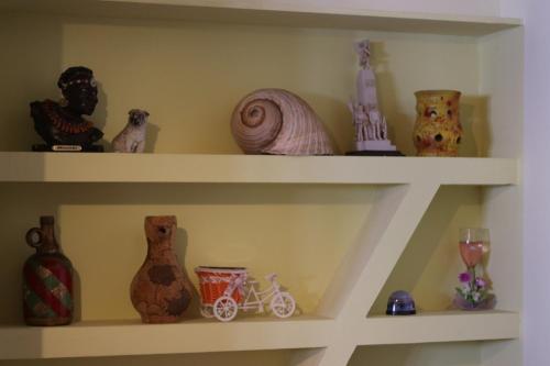 a shelf with vases and other items on it at Vila Bajrami in Vlorë