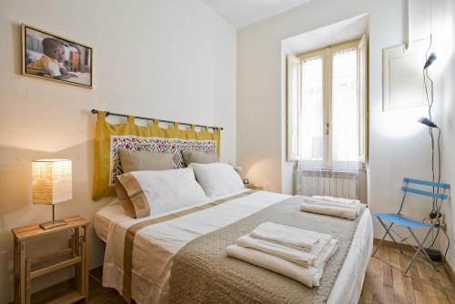 a bedroom with a large bed with towels on it at Casa Elena in Rome