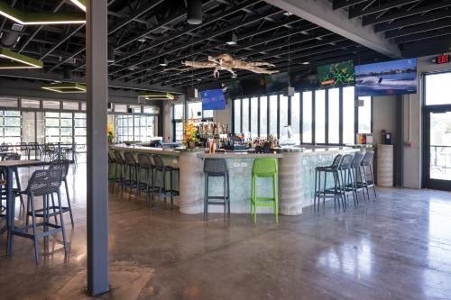 a bar with green bar stools in a restaurant at Natura Treescape Resort in Wisconsin Dells
