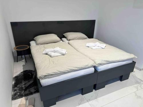 two beds in a room with towels on them at Boka Apartments in Kuršumlija