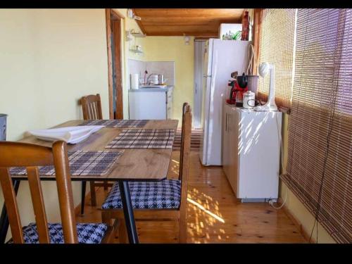 a kitchen with a table and a refrigerator at kali SunnySide Up in Nea Kalikratia