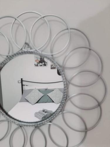a metal circular mirror with a room in it at Tra Vento e Mare in Lendinuso