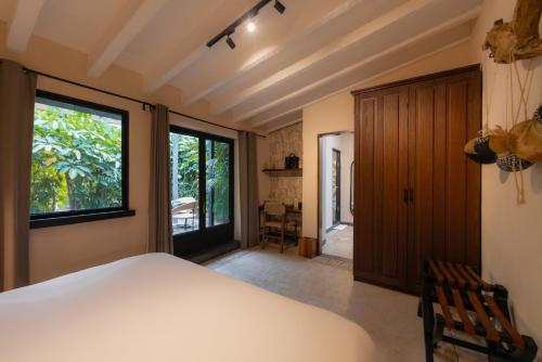 a bedroom with a bed and a large window at Amomoxtli in Tepoztlán